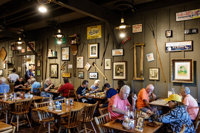 Customers dining inside Cracker Barrel Country Store restaurant.
