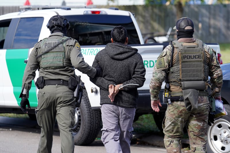 U.S. Border Patrol agents detain a man on the street on December 3, 2025 in New Orleans, Louisiana.