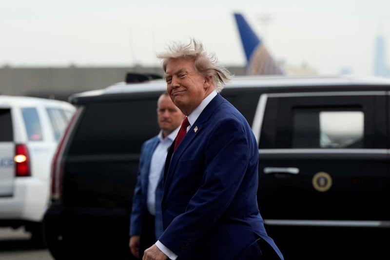 U.S. President Donald Trump walks at Newark Liberty International Airport as he travels en route to Trump National Golf Club Bedminster in Newark, New Jersey, U.S.