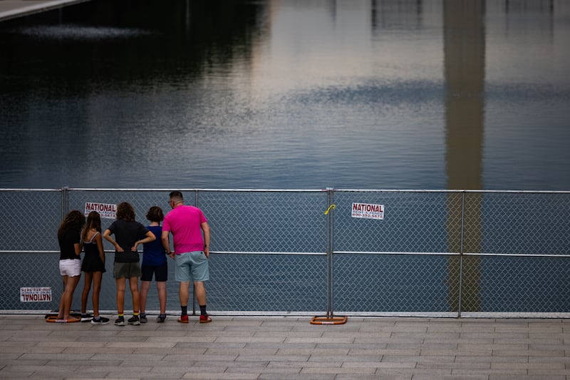 People view the Lincoln Memorial Reflecting Pool from behind a fence on June 27, 2026 in Washington, DC. Fencing has been installed around the area after claims made by President Trump that vandalism was the cause of the damage.