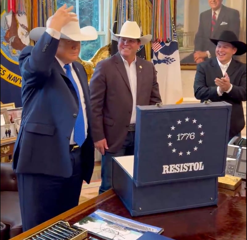 Donald Trump tries on the Resistol 1776 in the Oval Office.