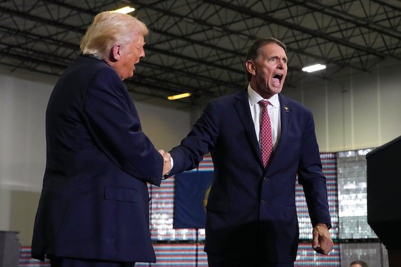 President Donald Trump shakes hands with Republican Kentucky congressional candidate Ed Gallrein as they speak on stage at Verst Logistics on March 11, 2026 in Hebron, Kentucky.