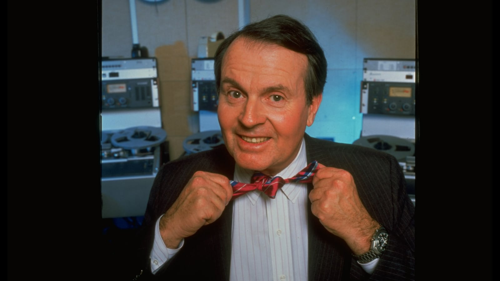 Radio reporter Charles Osgood untieing bow tie at CBS Radio Studios.