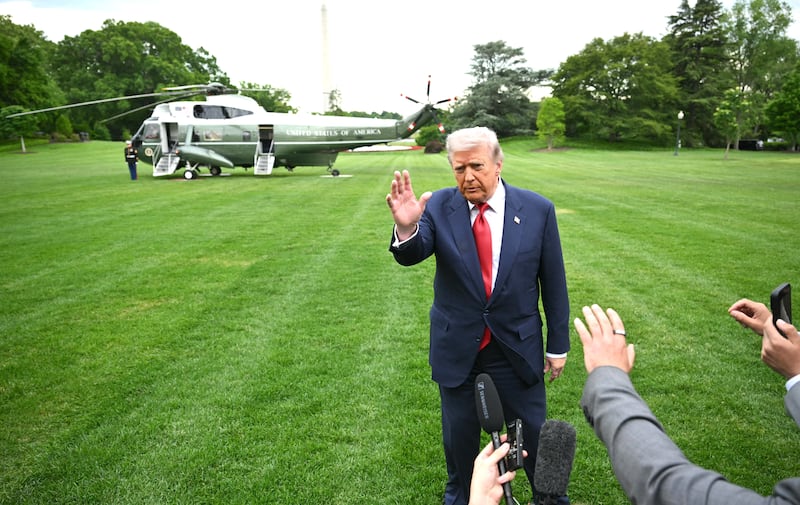 US President Donald Trump speaks to journalists as he makes his way to board Marine One