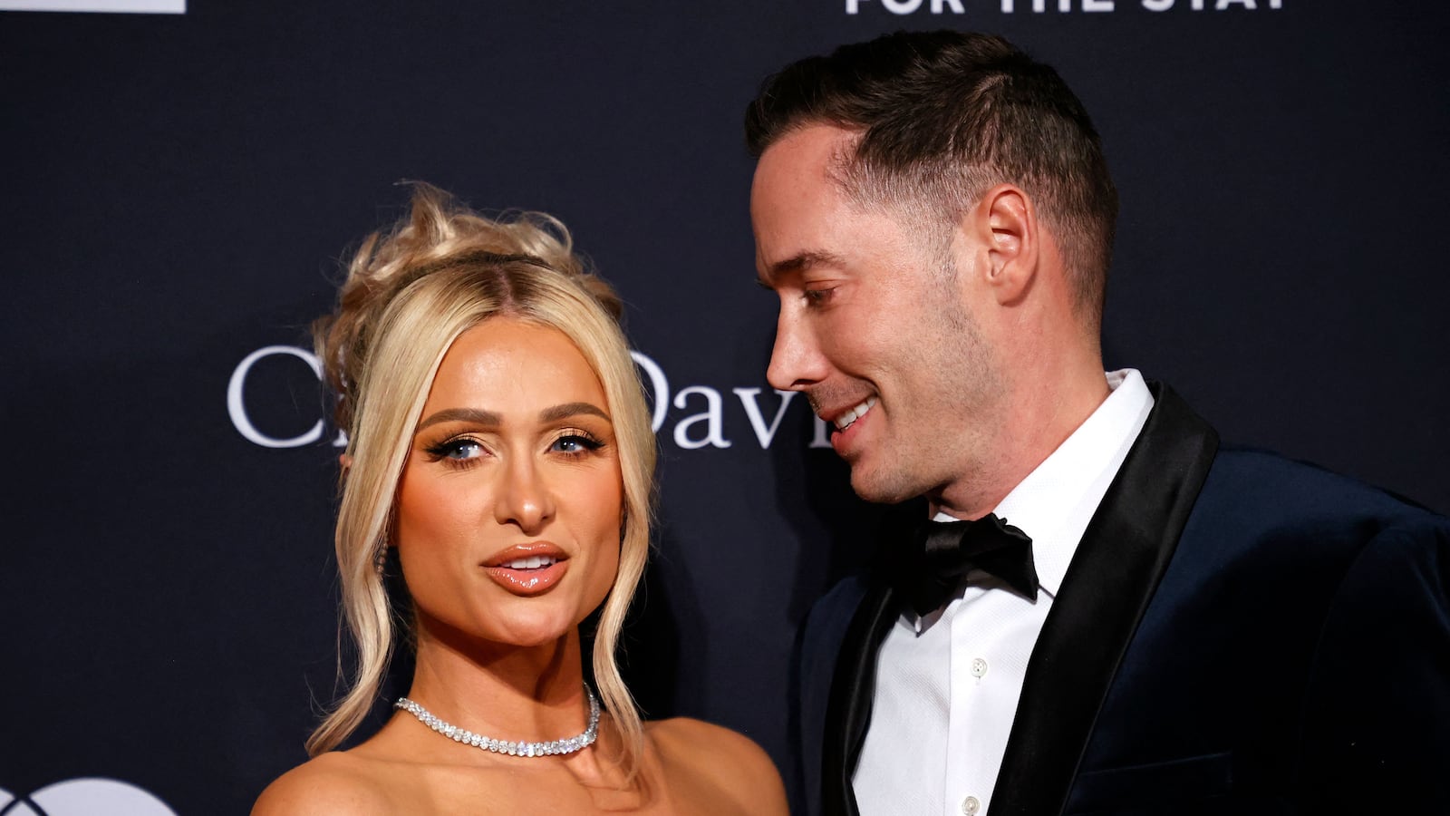 US socialite Paris Hilton (L) and husband US author Carter Reum arrive for the Recording Academy and Clive Davis pre-Grammy gala at the Beverly Hilton hotel in Beverly Hills, California on February 4, 2023. (Photo by Michael TRAN / AFP) (Photo by MICHAEL TRAN/AFP via Getty Images)