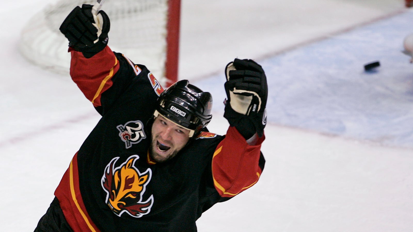 Chris Simon celebrates scoring a goal for the Calgary Flames.