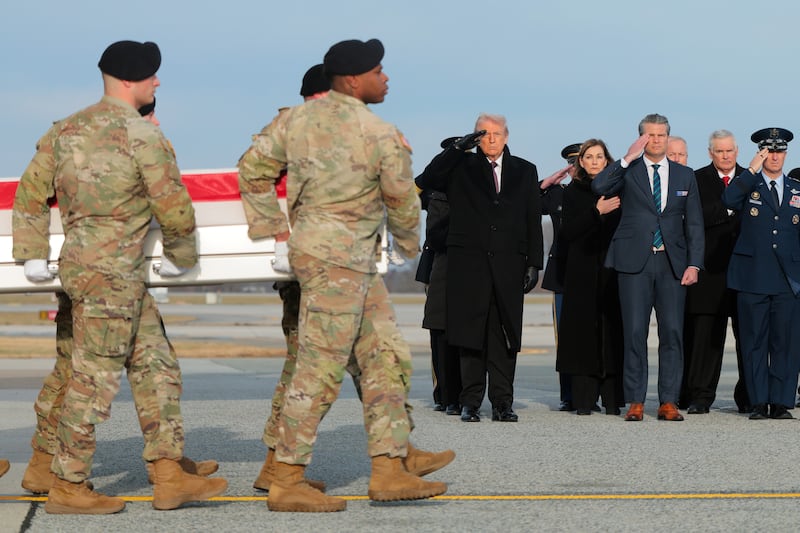 DOVER, DELAWARE - DECEMBER 17: U.S. President Donald Trump and U.S. Secretary of War Pete Hegseth salute as a U.S. Army carry team moves a flagged-draped transfer case containing the remains of Iowa National Guardsman Sgt. Edgar Brian Torres-Tovar at Dover Air Force Base on December 17, 2025 in Dover, Delaware. Iowa National Guard members Sgt. William Nathaniel Howard and Sgt. Edgar Brian Torres-Tovar and Ayad Mansoor Sakat, a U.S. civilian working as an interpreter, were killed during a recent ambush by an Islamic State (IS) gunman in Syria. (Photo by Anna Moneymaker/Getty Images)