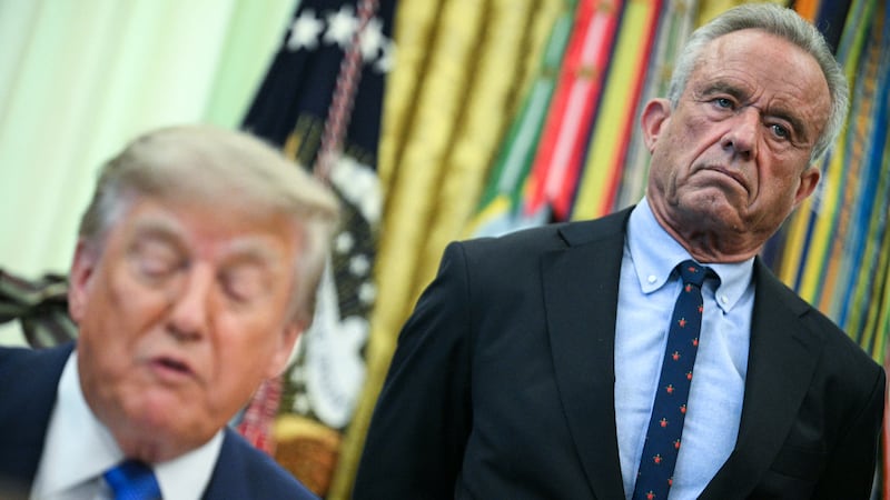 U.S. Secretary of Health and Human Services Robert F. Kennedy Jr. (R) looks on as President Donald Trump speaks before signing an executive order calling for more research and flexibility on vaccines.
