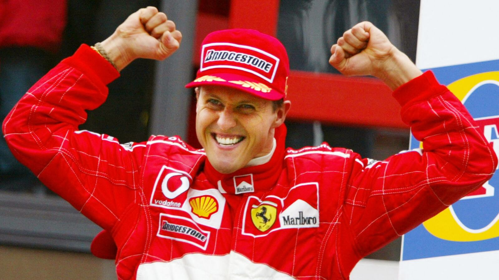 German Ferrari driver Michael Schumacher jubilates on the podium of the Spa-Francorchamps racetrack, 01 September 2002, after winning the Belgian Formula One Grand Prix. Schumacher won the race ahead of Brazilian Ferrari driver Rubens Barrichello, and Colombian BMW-Williams driver Juan Pablo Montoya. AFP PHOTO PATRICK HERTZOG (Photo by AFP) (Photo by -/AFP via Getty Images)