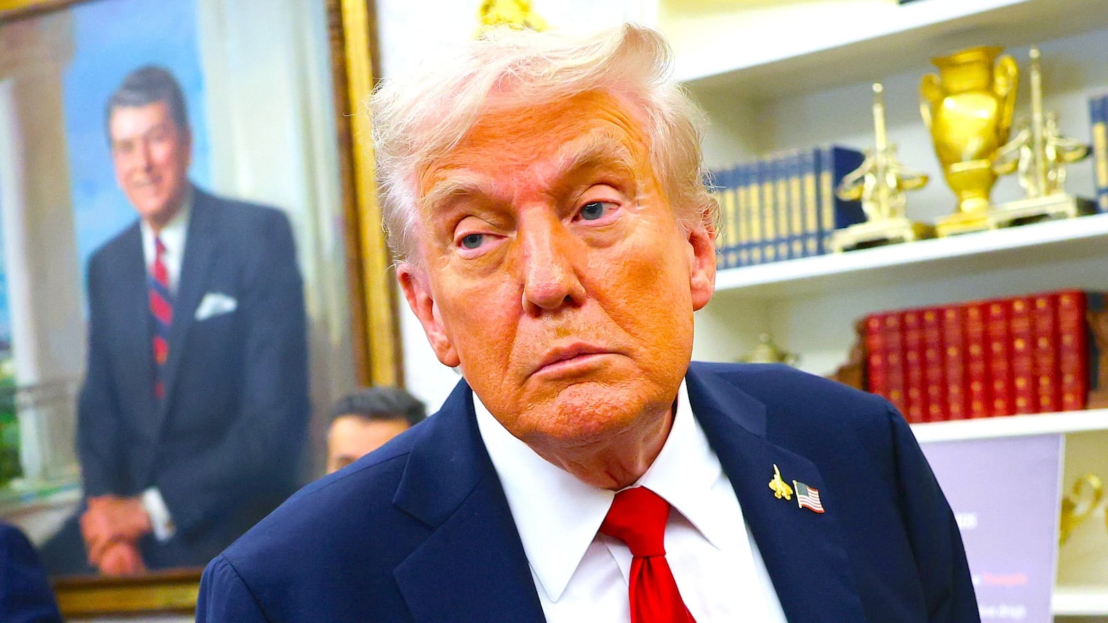 President Donald Trump listens to a question from a reporter after announcing a deal with Pfizer to lower Medicaid drug prices in the Oval Office of the White House on September 30, 2025 in Washington, DC. T