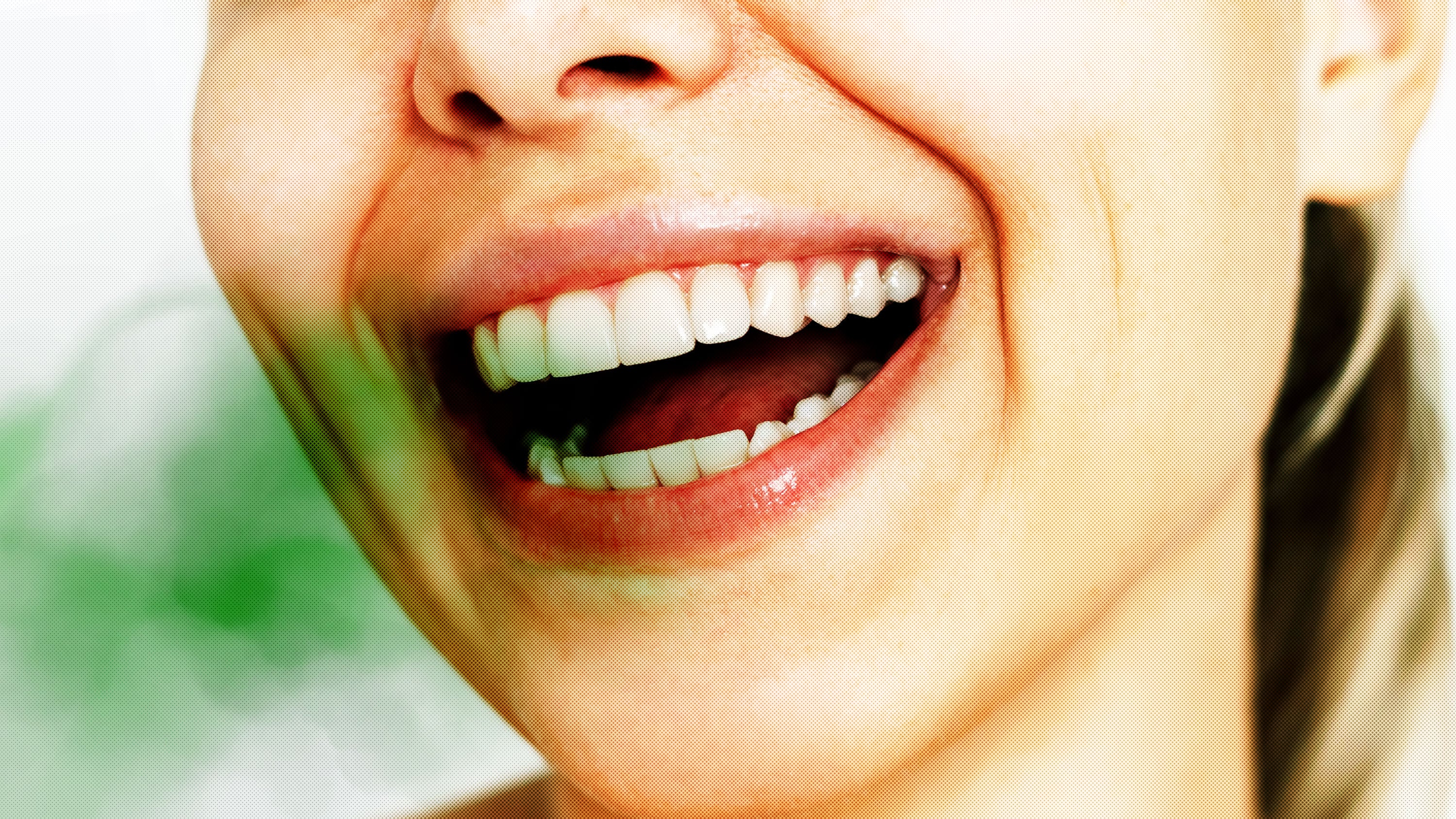 Woman smiling with an open mouth and straight teeth with a green odor blob coming out of her mouth showing bad breath