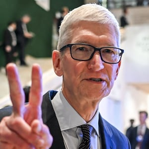 Apple CEO Tim Cook gestures as he departs after a business leaders reception with the US President on the sidelines of the World Economic Forum (WEF) annual meeting in Davos on January 21, 2026.