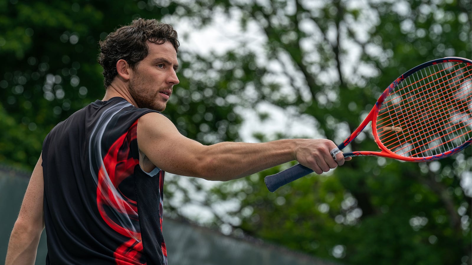 Josh O'Connor holds a racket in a still from 'Challengers'