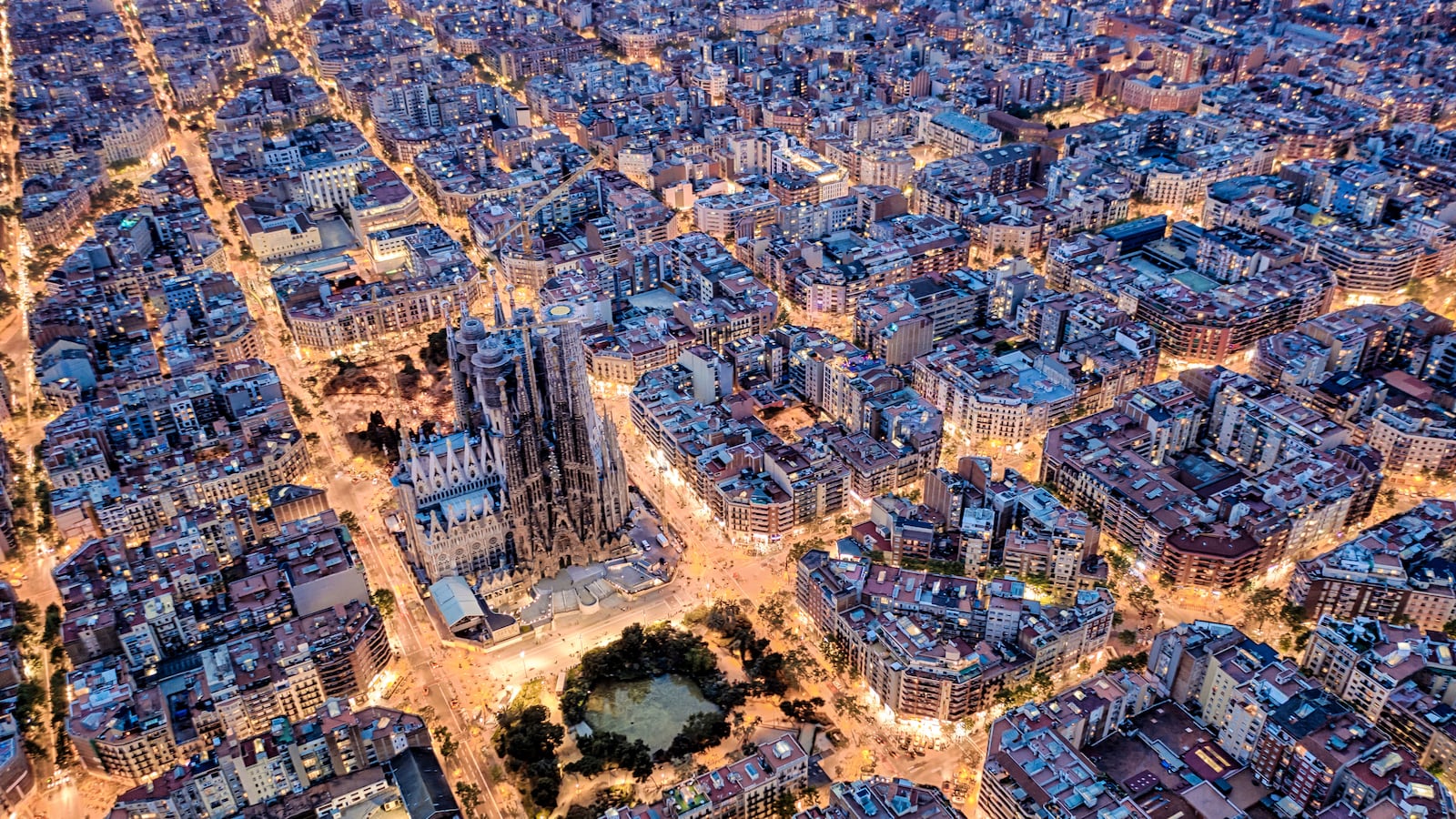 An aerial photograph of Barcelona with Sagrada Familia in the center.
