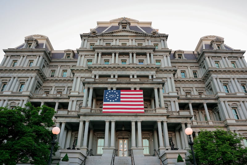 An America250 flag decorates the Eisenhower Executive Office Building, which U.S. President Donald Trump's administration has proposed to paint white, in Washington, D.C., U.S., May 7, 2026.