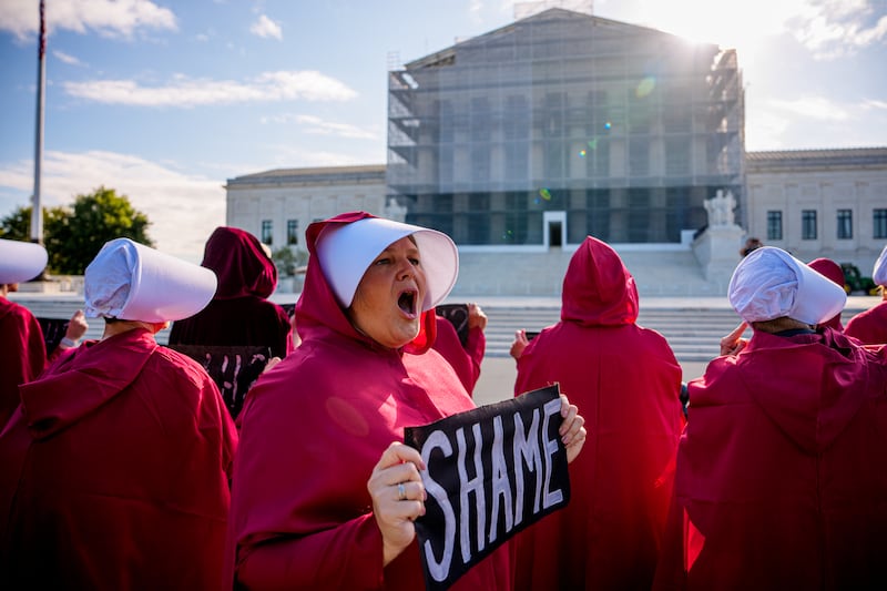 Women dressed as handmaids from "The Handmaid's Tale" protest in front of the Supreme Court on September 2, 2025 in Washington, D.C.