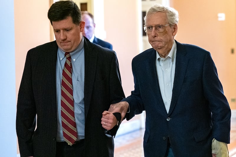 Then-Senate Minority Leader Mitch McConnell is assisted by staff as he goes to the Senate Chamber to vote on December 11, 2024 in Washington, DC. According to a statement released by his office, the Kentucky Republican fell after tripping following a lunch, spraining his wrist and sustaining a minor cut to his face. The incident is the latest in a high-profile string of health issues for the 82-year-old senator.