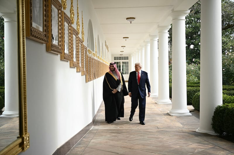 US President Donald Trump and Crown Prince and Prime Minister of the Kingdom of Saudi Arabia Mohammed bin Salman walk down the Colonnade on the way to the Oval Office of the White House in Washington, DC on November 18, 2025. Saudi Crown Prince Mohammed bin Salman arrived at the White House to fanfare and a jet flyover Tuesday, in his first visit to the United States since the 2018 murder of journalist Jamal Khashoggi. (Photo by Brendan SMIALOWSKI / AFP) (Photo by BRENDAN SMIALOWSKI/AFP via Getty Images)