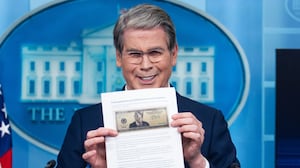 Treasury Secretary Scott Bessent holds a printout of a proposed $250 bill featuring a picture of President Donald Trump