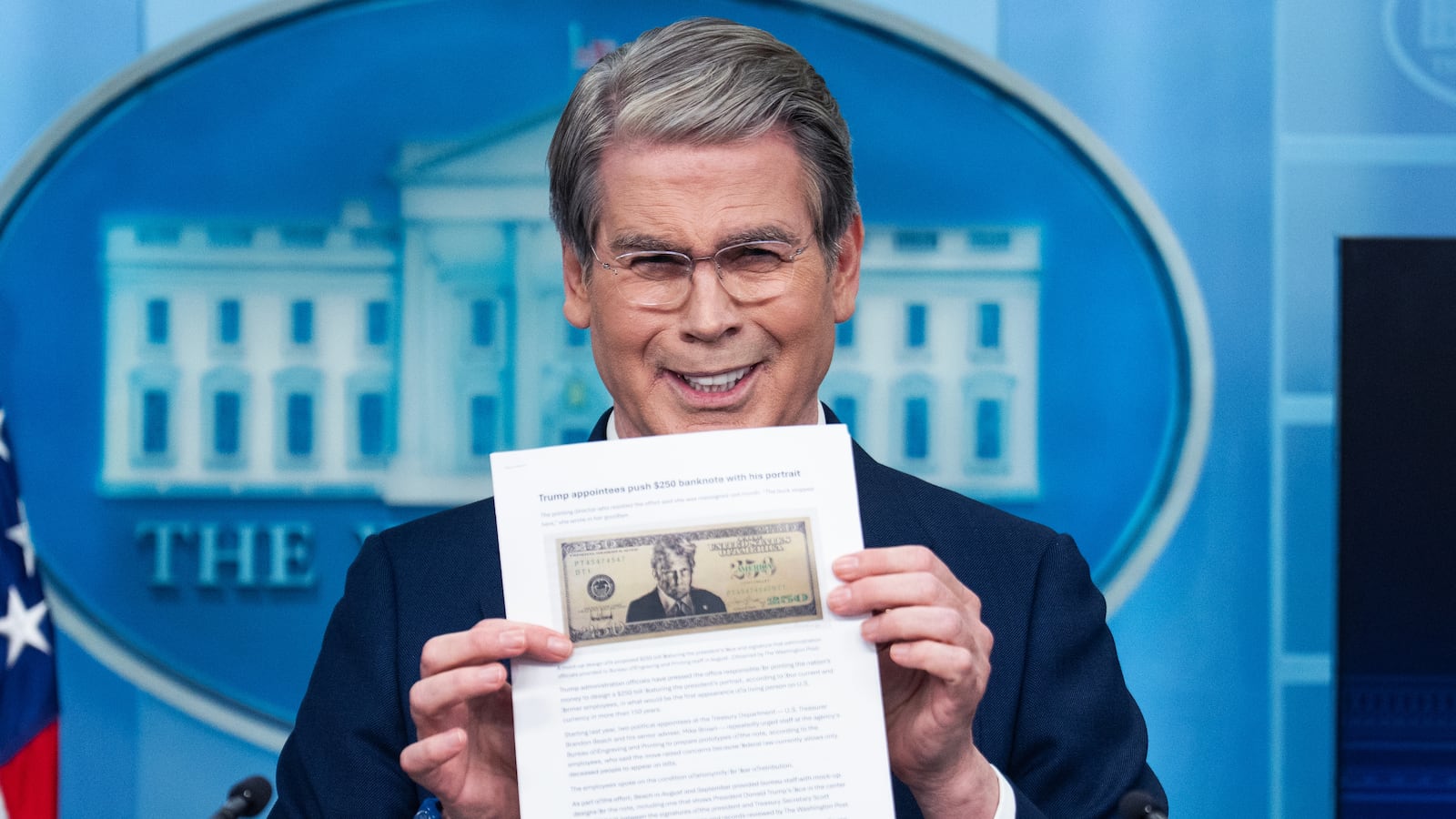 Treasury Secretary Scott Bessent holds a printout of a proposed $250 bill featuring a picture of President Donald Trump