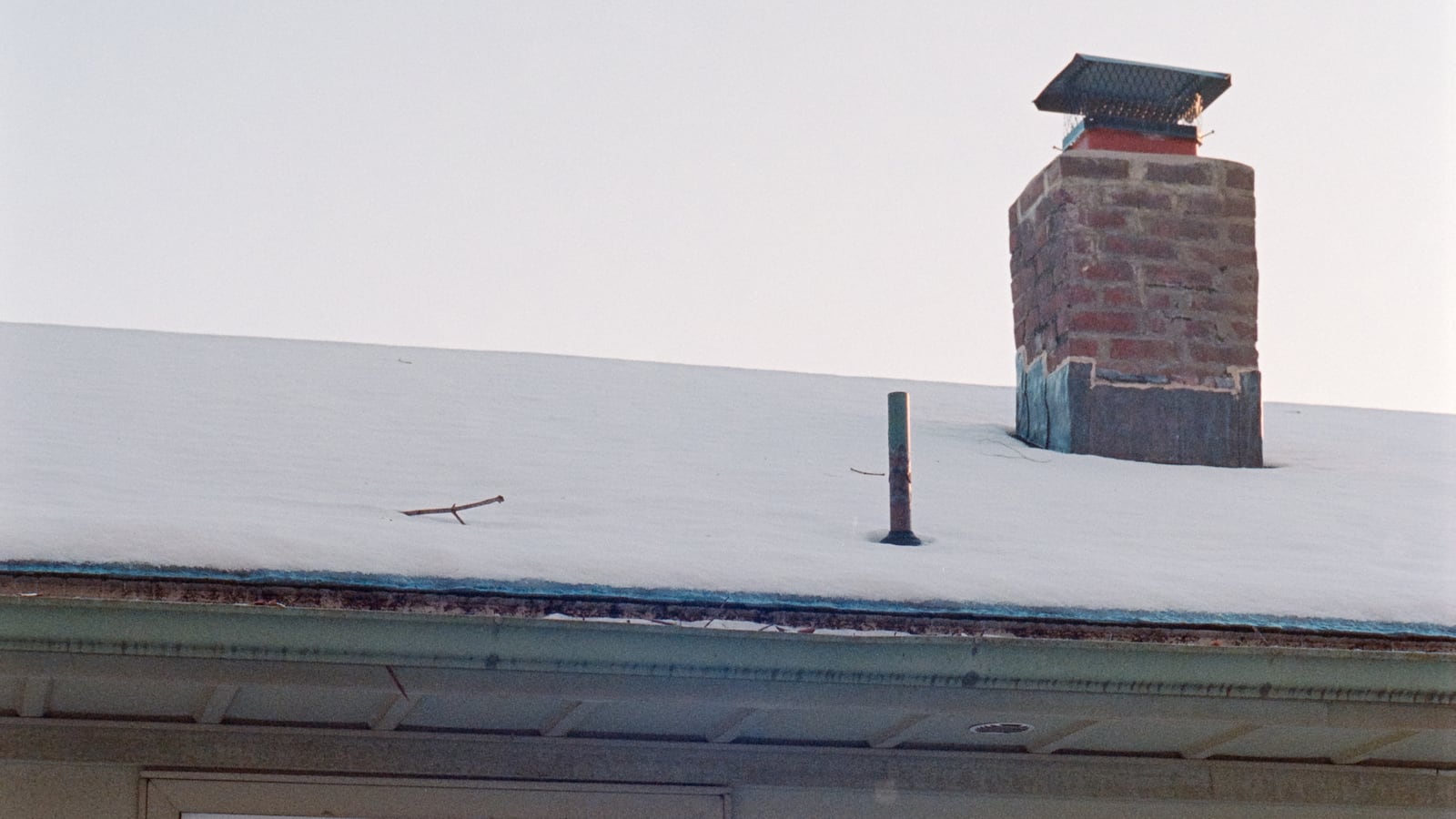 Chimney on snowy roof