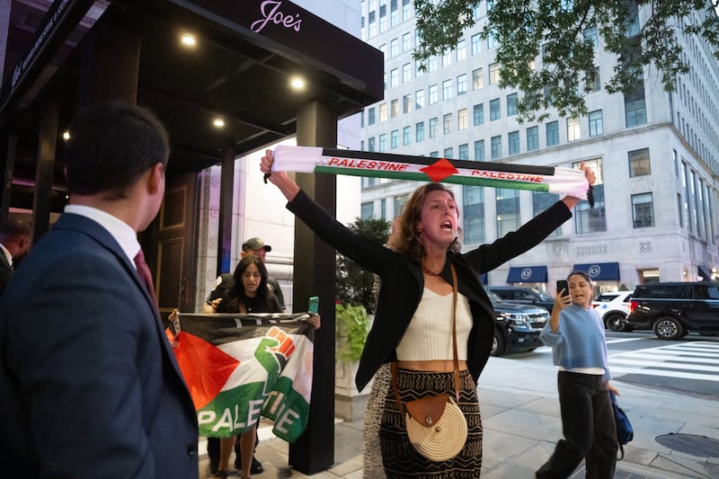 Pro-Palestinian protesters leave the restaurant Joe's Seafood, Prime Steak & Stone Crab as the US president dines there in Washington, DC, on September 9, 2025. (Photo by SAUL LOEB / AFP) (Photo by SAUL LOEB/AFP via Getty Images)