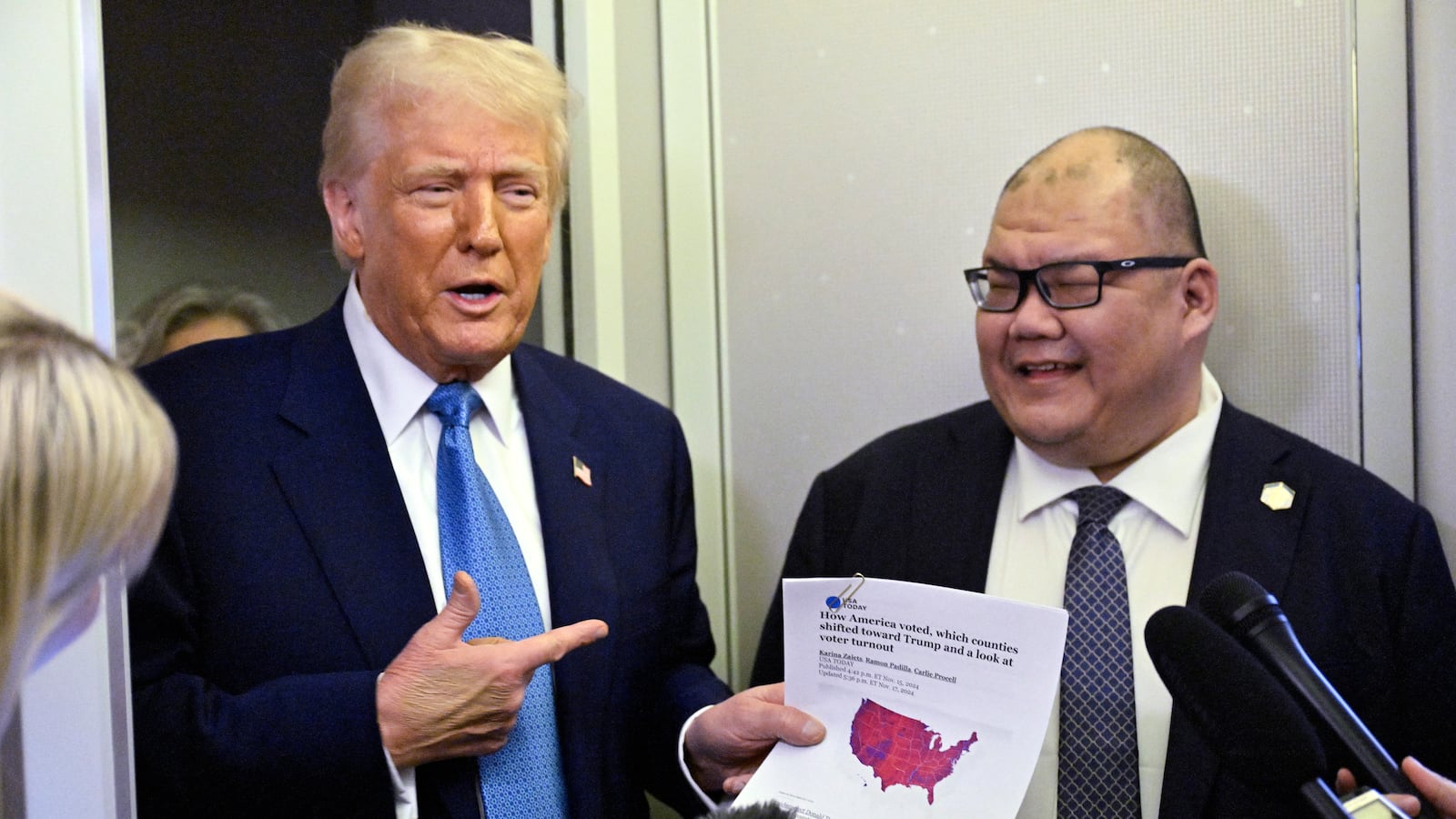 US President Donald Trump speaks with journalist, alongside White House Communications Director Steven Cheung (R), on board Air Force One on route from Miami, Florida, to the White House in Washington, DC on February 19, 2025. (Photo by ROBERTO SCHMIDT / AFP) (Photo by ROBERTO SCHMIDT/AFP via Getty Images)