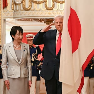 Japan's Prime Minister Sanae Takaichi (L) and US President Donald Trump review an honour guard of the Japan Self-Defense Force