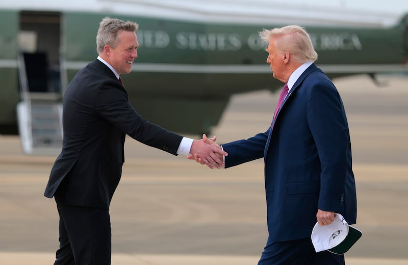 President Donald Trump is greeted by Secretary of the Army Daniel Driscoll as he arrives at Pope Army Airfield on June 10, 2025 in Fort Bragg, North Carolina.