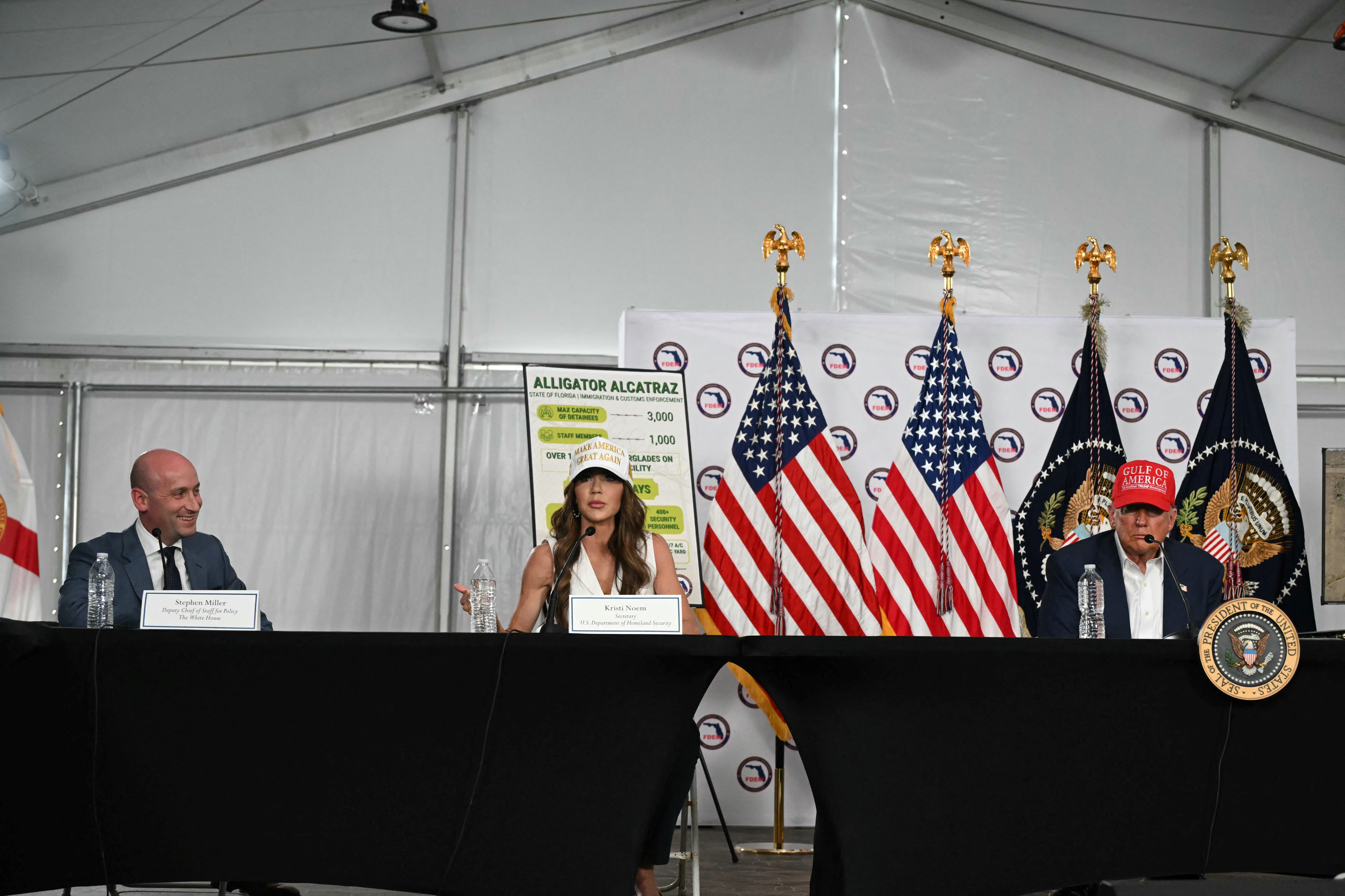 Kristi Noem, President Donald Trump and Stephen Miller