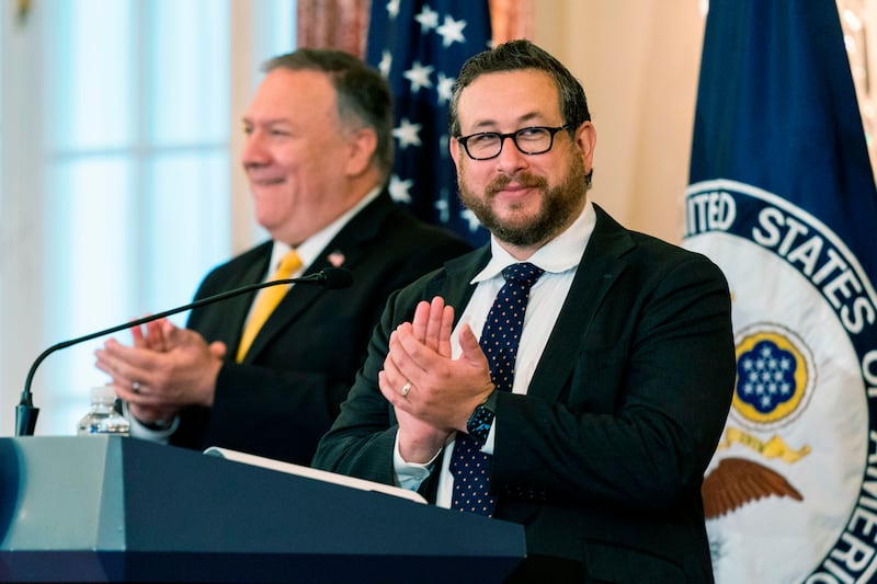 US Citizenship and Immigration Services (USCIS) Deputy Director for Policy Joseph Edlow,(R) and Secretary of State Mike Pompeo, applaud and congratulate new US citizens during a naturalization ceremony hosted by the USCIS at the State Department in Washington, DC, on October 22, 2020. (Photo by Manuel Balce Ceneta / POOL / AFP) (Photo by MANUEL BALCE CENETA/POOL/AFP via Getty Images)