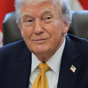U.S. President Donald Trump smiles during an event to sign an executive order creating an anti‑fraud task force headed by U.S. Vice President JD Vance in the Oval Office at the White House in Washington, D.C., U.S., March 16, 2026.
