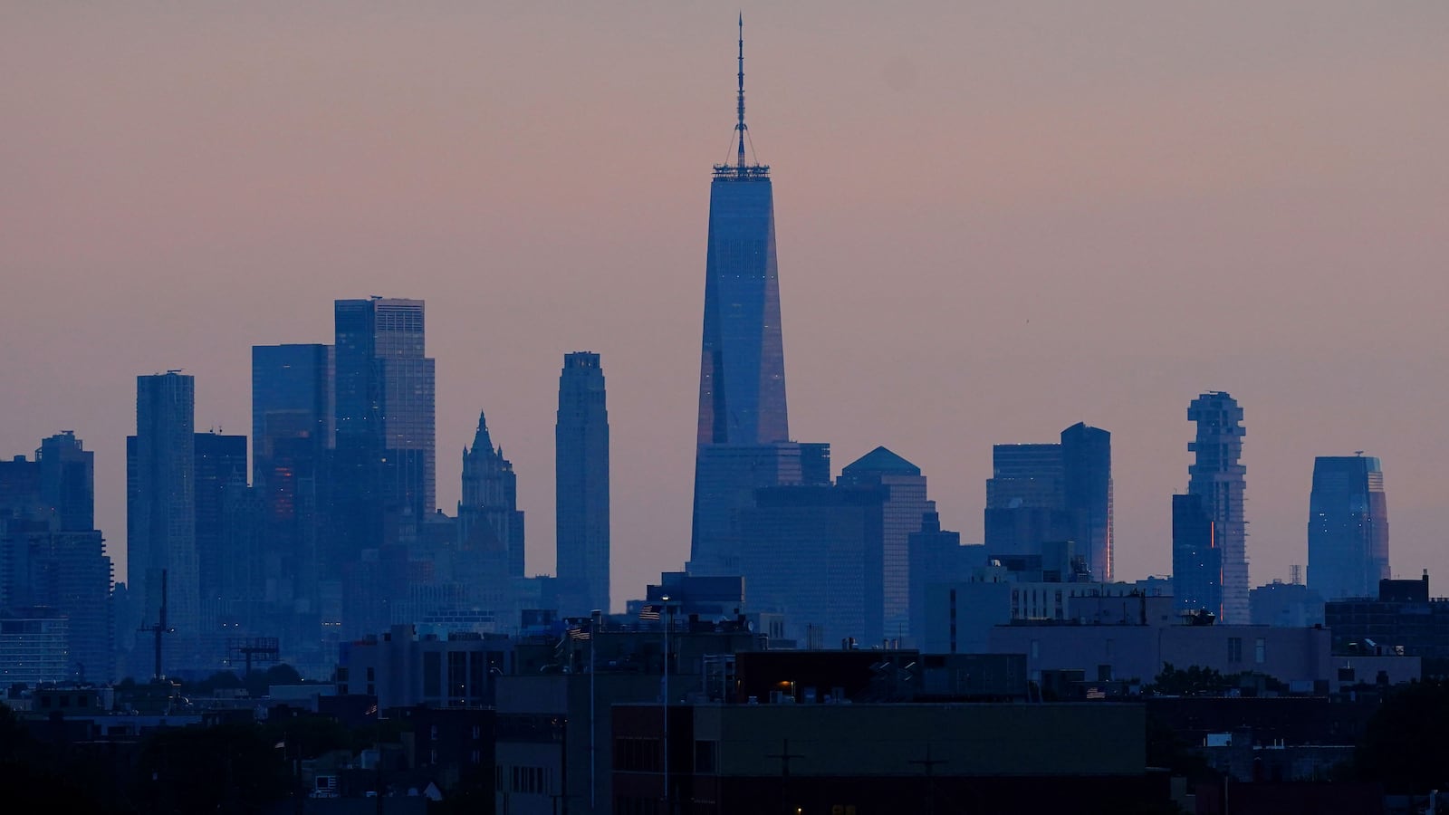 A general view as the sun sets behind the New York City skyline.