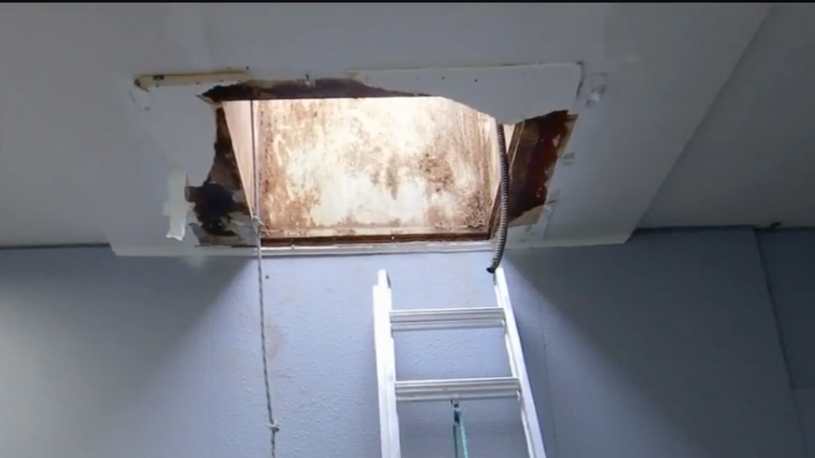 A hole in the roof used by thieves to steal cars at Northtown Auto Sales in Spokane, Washington.