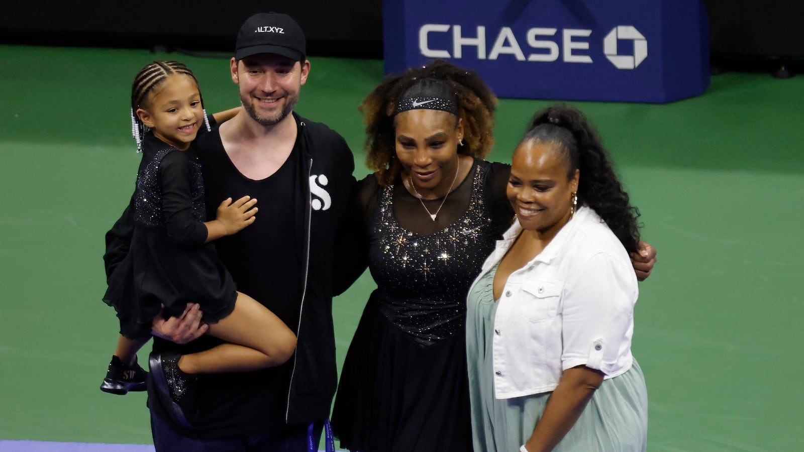 Serena Williams poses for a picture with daughter Olympia, husband Alexis Ohanian, and sister Isha Price.
