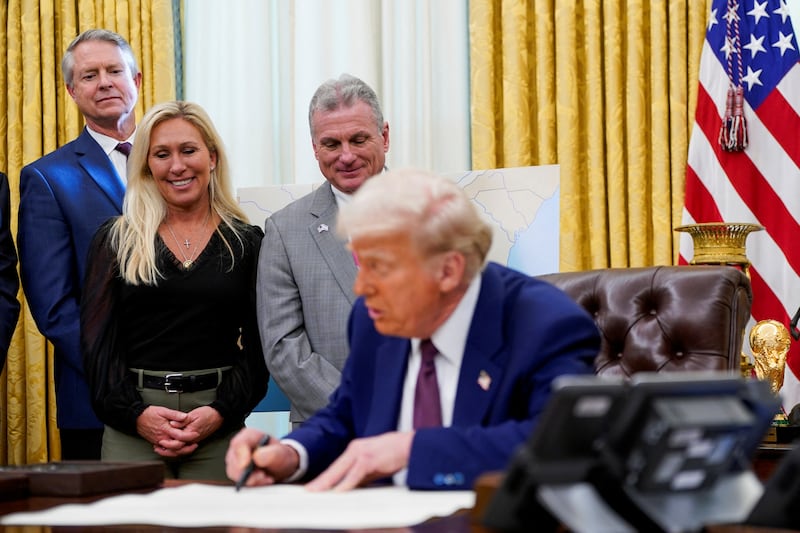U.S. President Donald Trump signs the commission certificate of Robert F. Kennedy Jr. next to U.S. Senator Roger Marshall (R-KS), U.S. Representatives Marjorie Taylor Greene (R-GA) and Buddy Carter (R-GA), on the day Kennedy is sworn in as secretary of Health and Human Services, in Washington, D.C., U.S., February 13, 2025. REUTERS/Nathan Howard
