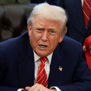 U.S. President Donald Trump sits behind a bill he signed to end the partial government shutdown, at the White House in Washington, D.C., U.S., February 3, 2026. REUTERS/Evelyn Hockstein