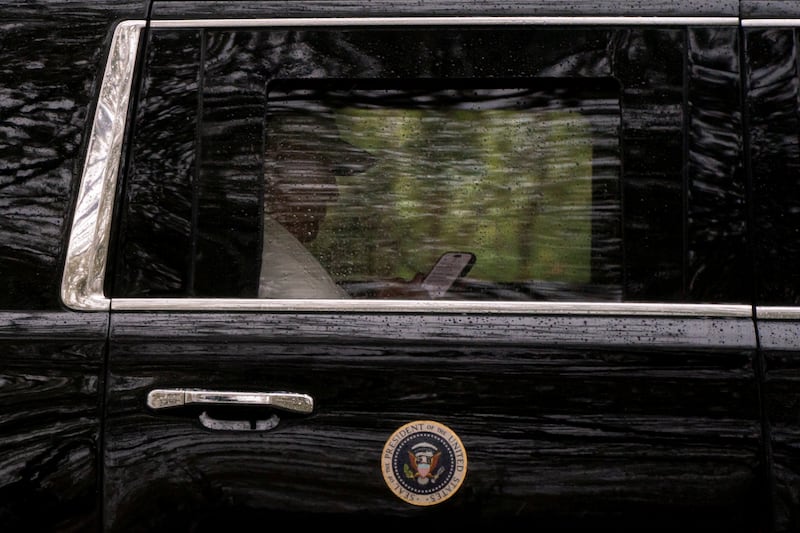 U.S. President Donald Trump uses a cell phone while departing from Trump National Golf Club en route to the White House in Sterling, Virginia., U.S., April 5, 2026. REUTERS/Nathan Howard