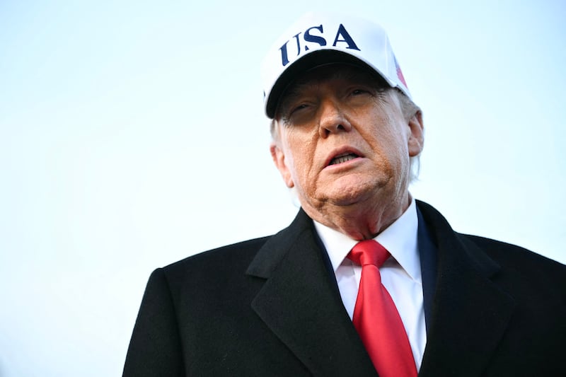 US President Donald Trump speaks to the press upon returning to Joint Base Andrews in Maryland on January 13, 2026. Trump is returning from speaking to The Detroit Economic Club in Detroit, Michigan, and a visit to a Ford production plant. (Photo by Mandel NGAN / AFP via Getty Images)