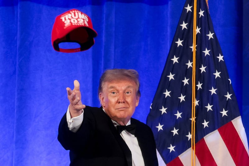 U.S. President Donald Trump throws a "Trump 2028" cap during mentalist Oz Pearlman's performance at the White House Correspondents' Association Dinner