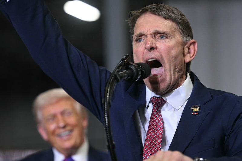 Former U.S. Navy SEAL officer Ed Gallrein speaks as U.S. President Donald Trump looks on.