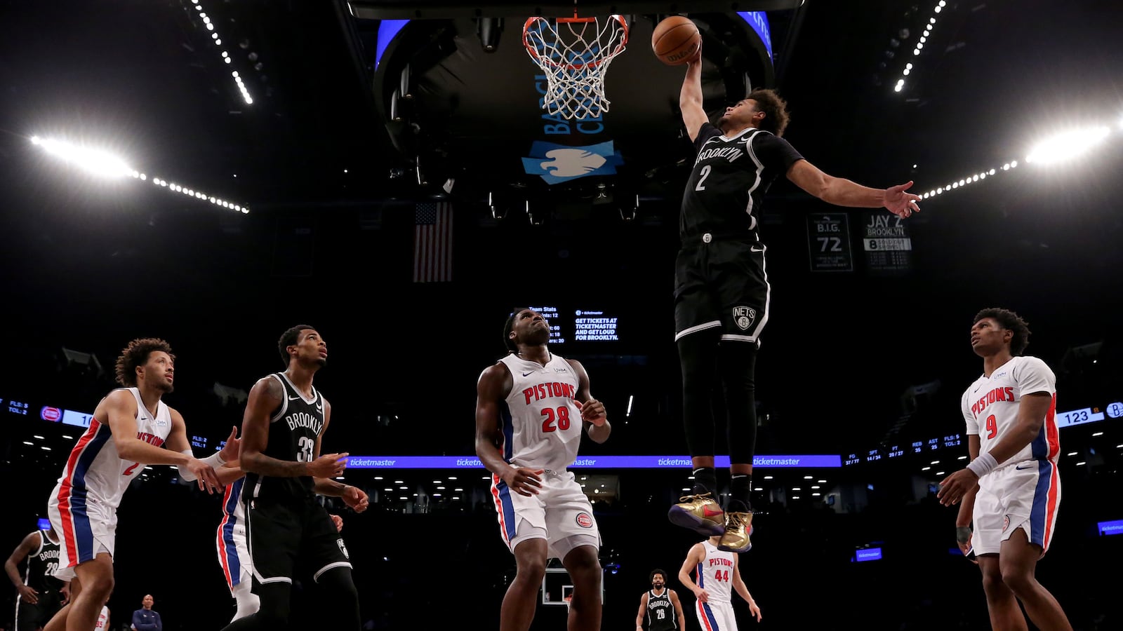 Brooklyn Nets forward Cameron Johnson (2) dunks against Detroit Pistons center Isaiah Stewart (28) and guard Cade Cunningham (2) and forward Ausar Thompson (9) during the fourth quarter at Barclays Center.