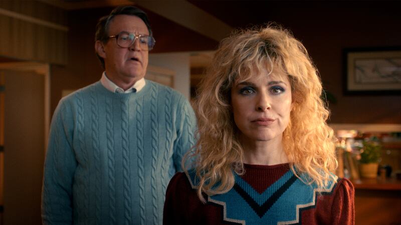 (L-R) Joe Chrest as Ted Wheeler and Cara Buono as Karen Wheeler in Stranger Things.