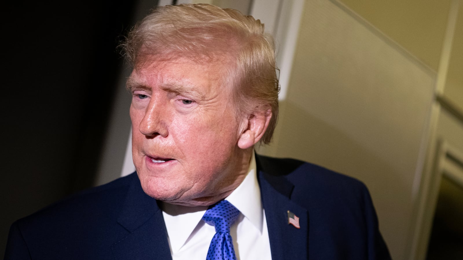 President Donald Trump speaks to members of the media aboard Air Force One while flying from Palm Beach International Airport on February 16, 2026 en route to Washington, DC.