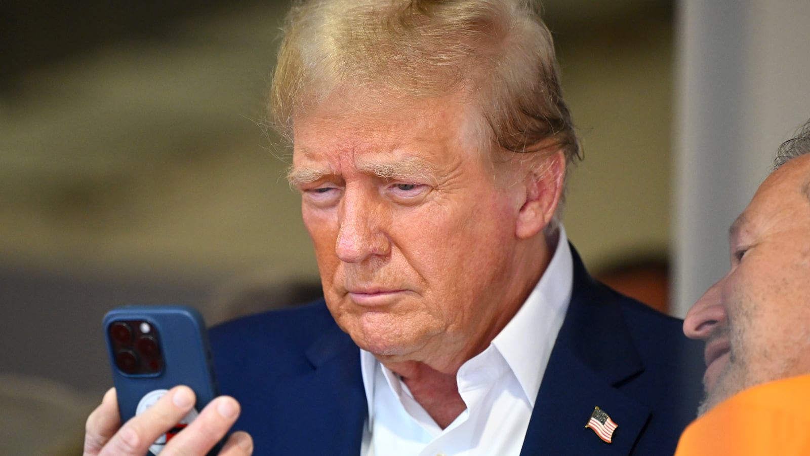 MIAMI, FLORIDA - MAY 05: Donald Trump talks on the phone in the McLaren garage prior to the F1 Grand Prix of Miami at Miami International Autodrome on May 05, 2024 in Miami, Florida. (Photo by Clive Mason/Getty Images)