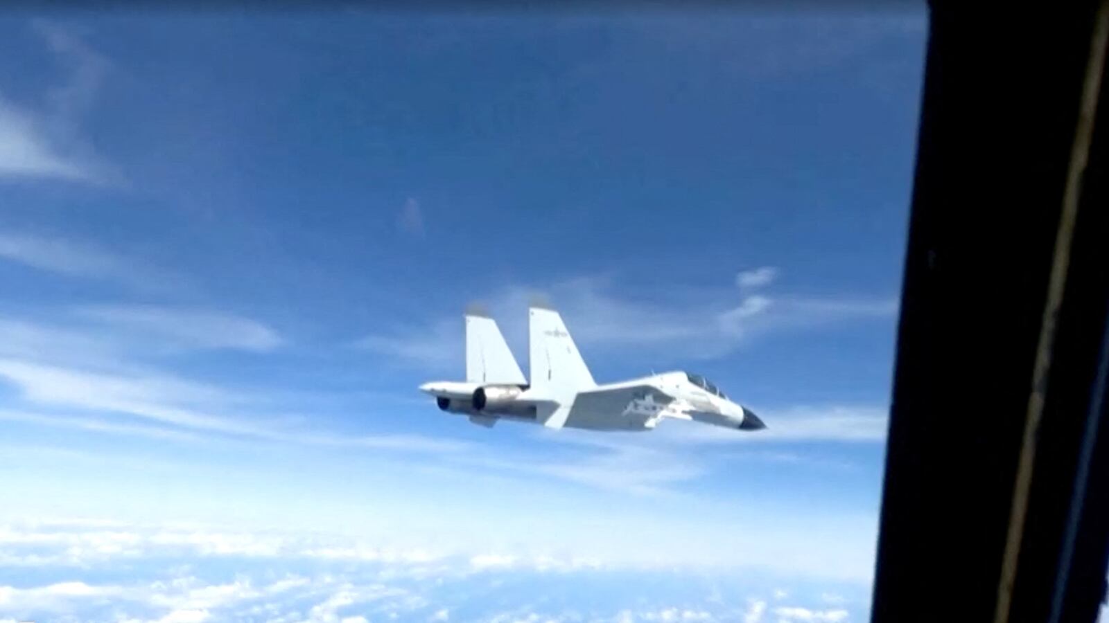 A Chinese military plane came within 20 feet (6 meters) of a U.S. Air Force aircraft, in this still image taken from a video, December 21, 2022.