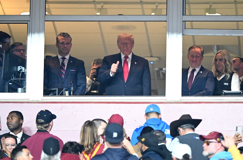 Secretary of Defense Pete Hegseth and President Donald Trump look on during a game between the Detroit Lions and the Washington Commanders at Northwest Stadium on November 09, 2025.
