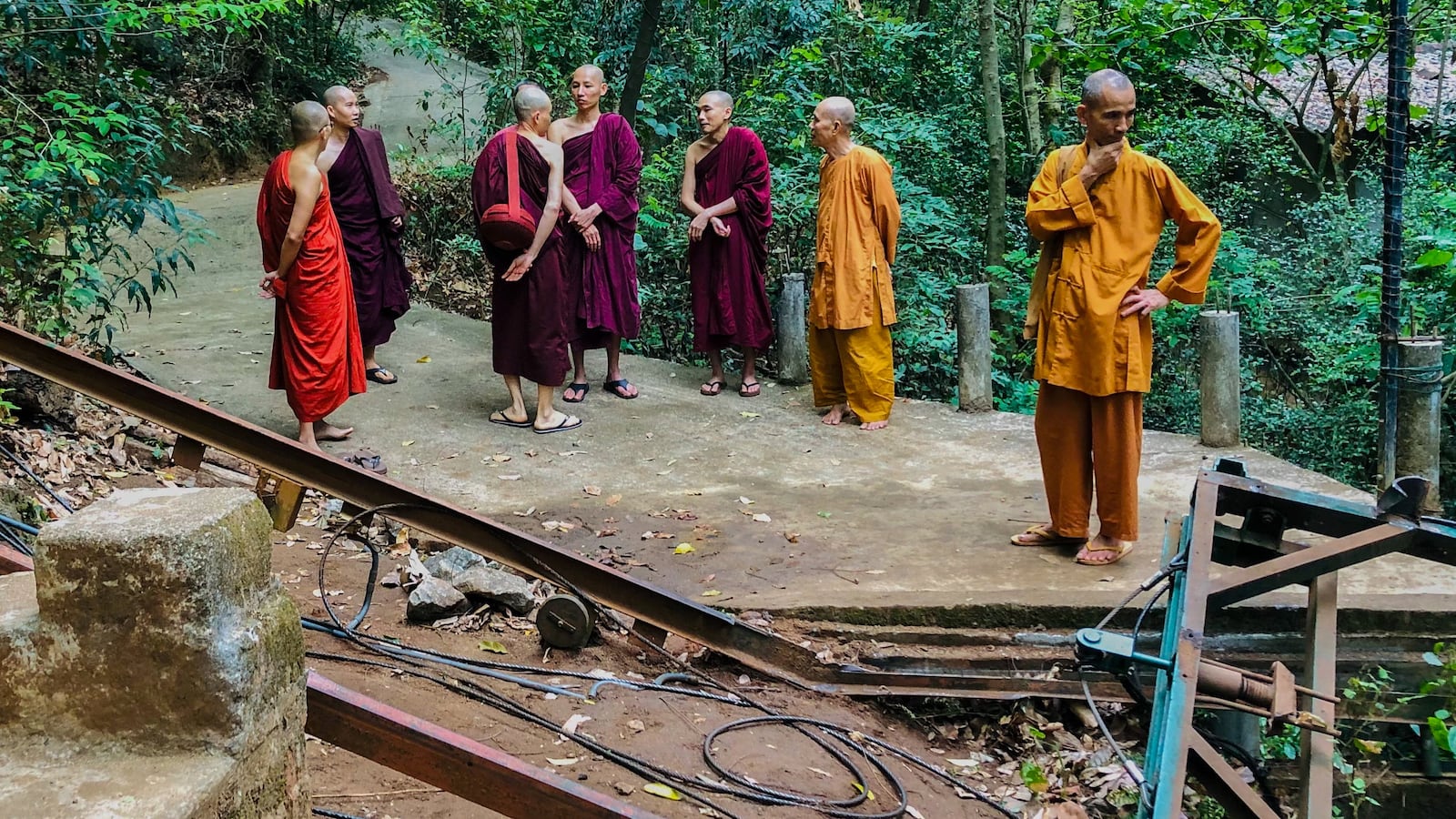 Buddhist monks stand at the site of a cable car accident in Sri Lanka's north-western district of Kurunegala on September 25, 2025. Seven Buddhist monks, including three foreigners, were killed when their cable-pulled rail car snapped and crashed down a mountainside in north-western Sri Lanka, police said on September 25.