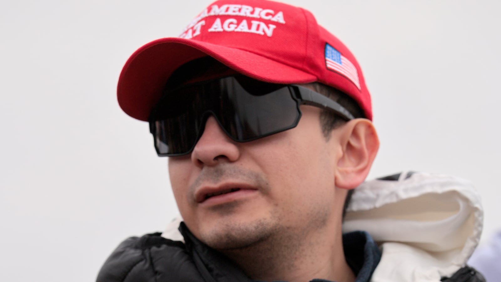 Bryan Betancur holds a Certificate of Pardon from President Donald Trump during a January 6th memorial march marking five years since the attack on January 06, 2026, in Washington, DC.