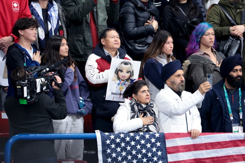 Arthur Liu, father of Alysa Liu - with her brother and sisters, Selina, Julia, Joshua and Justin - during the US national anthem after Alysa won the Gold Medal